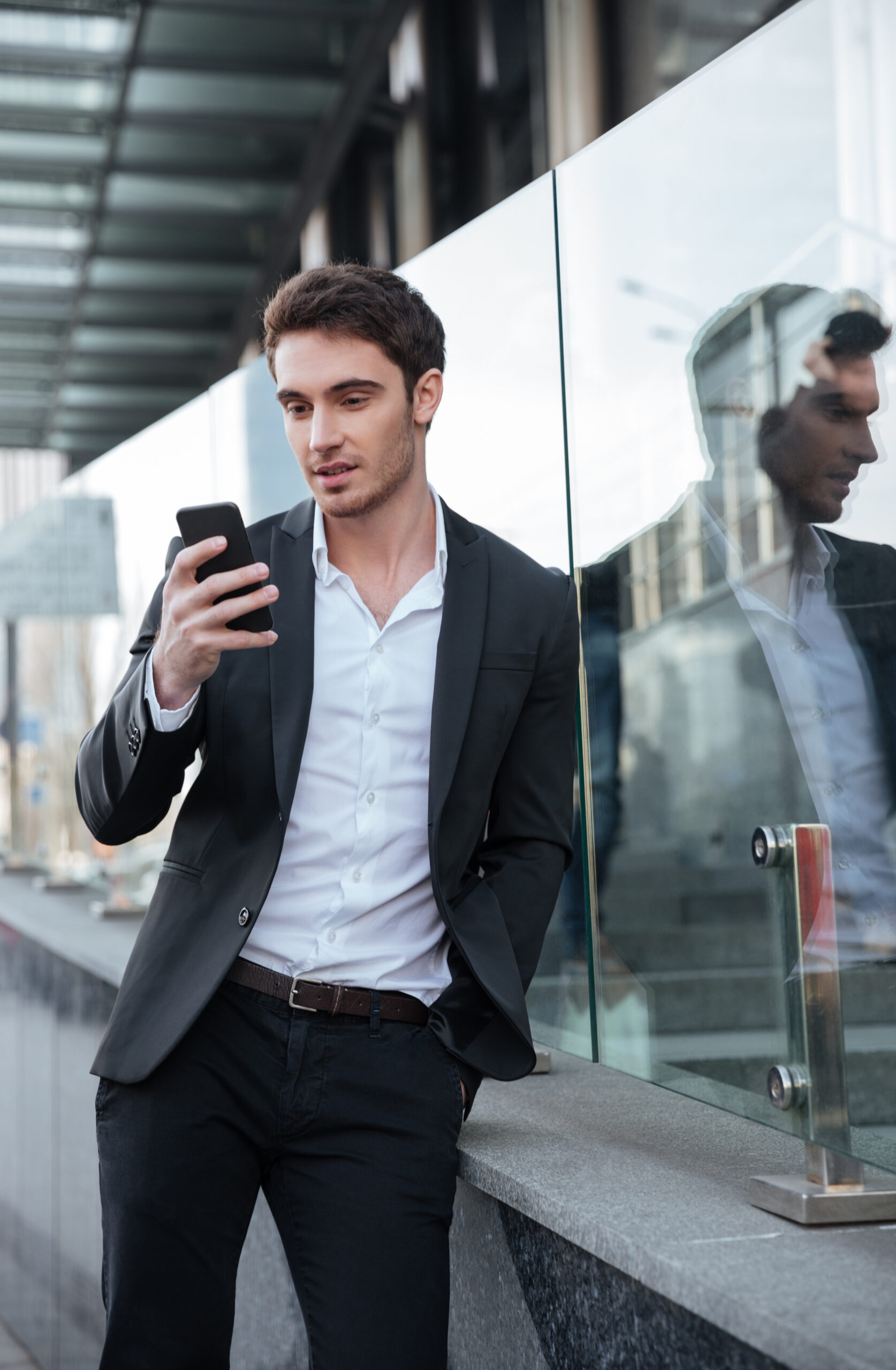 Man bekijkt mobiele telefoon met melding over zijn reservering of afspraak